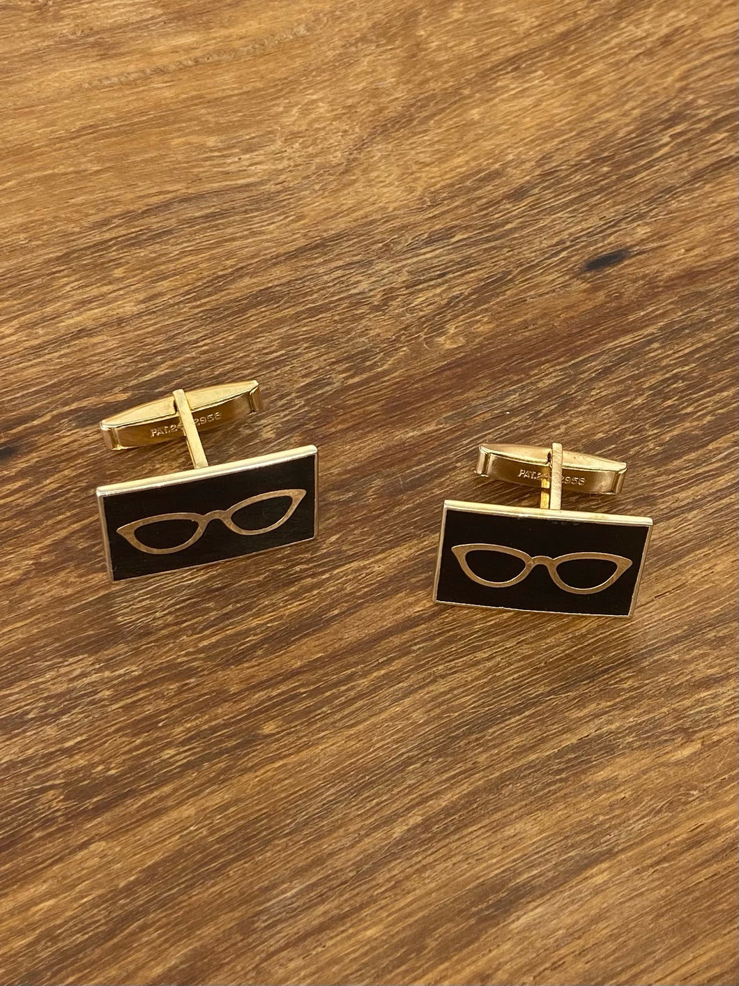 Very cool cufflinks. Gold-tone back and glasses decoration with black enamel.Patent 2472958