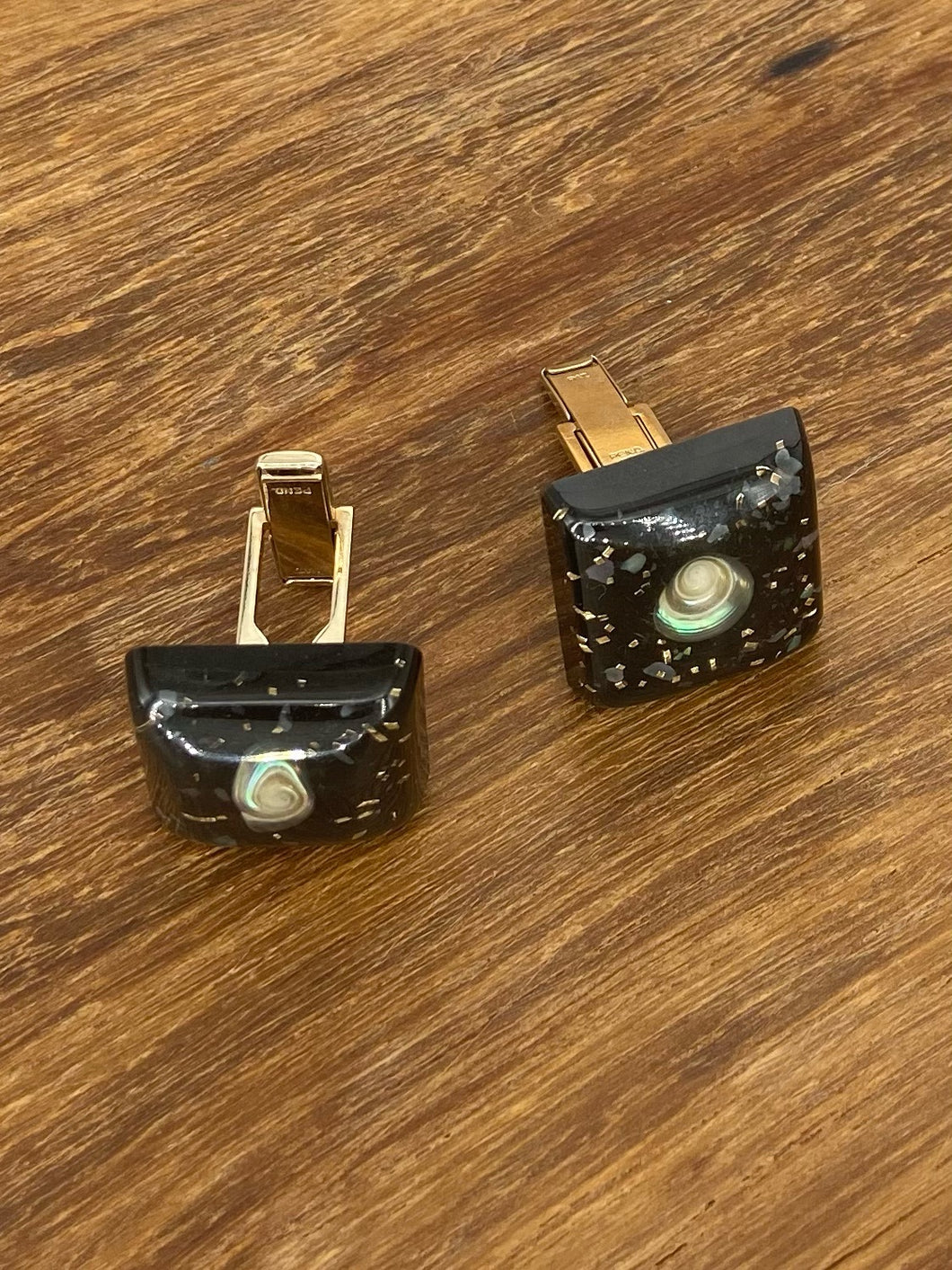Black Bakelite and Resin Cufflinks with a Shell Decoration.